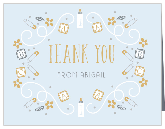 Bottles and blocks, safety pins and dots mingle with florals and swirls on the ABC Blocks Foil Thank You Cards.